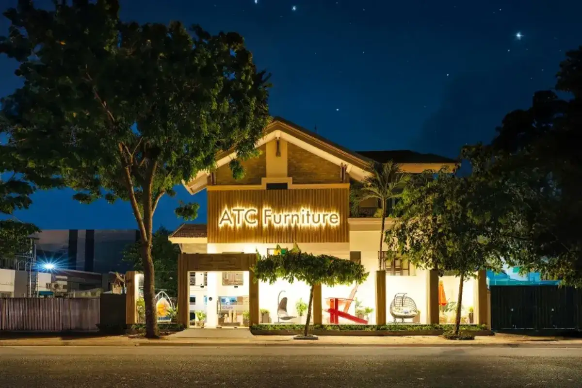 ATC Furniture showroom exterior at night with illuminated signage and outdoor furniture display