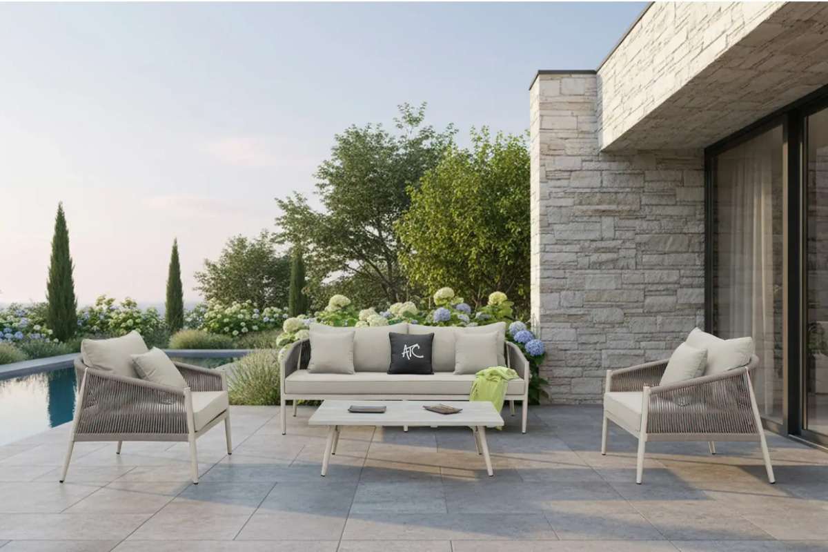 Outdoor 4-seater sofa set with a lightweight aluminum frame placed beside a modern villa and pool.
