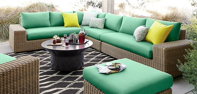 Synthetic rattan sofa set with weather-resistant green cushions