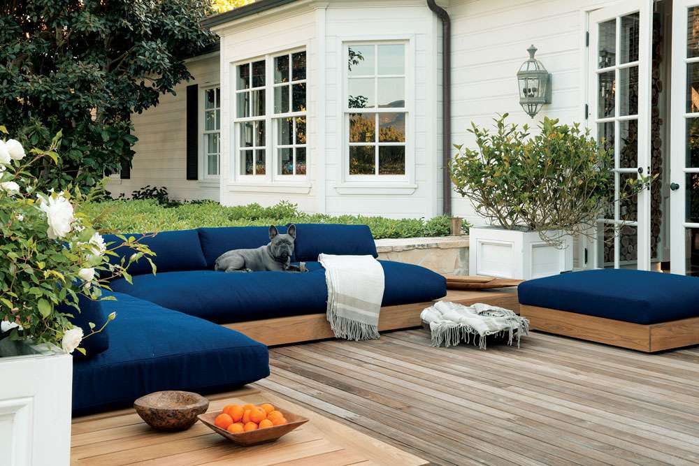 Relaxation chair with soft cushions surrounded by greenery