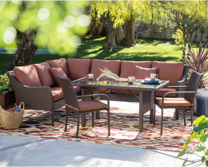 Patio furniture featuring a long sofa and contemporary dining table