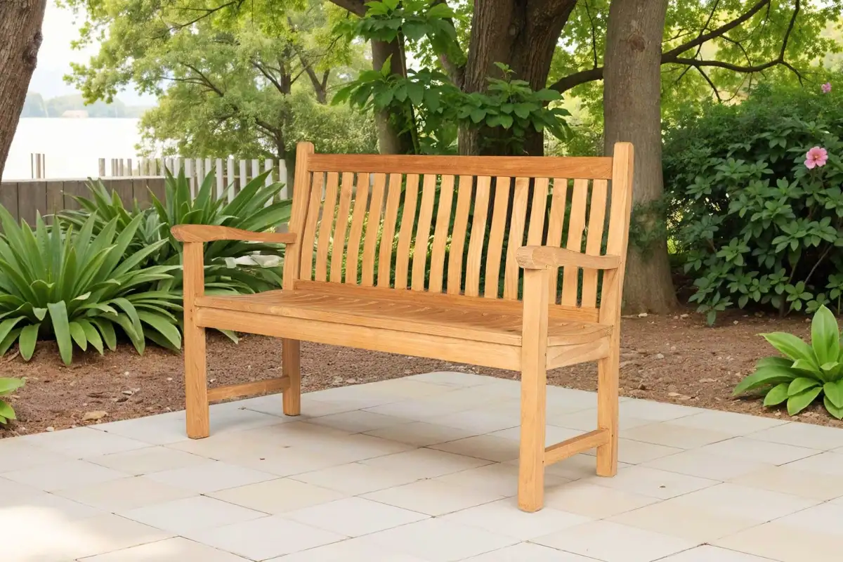 Outdoor teak wood bench in a lush green garden