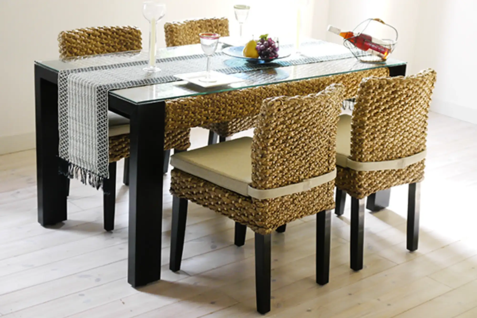 Water hyacinth dining chairs paired with a rectangular dining table, creating a warm and cohesive indoor dining setting.