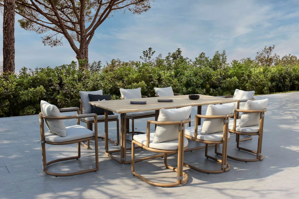 Modern outdoor dining set with minimalist wooden chairs and neutral cushions in a contemporary garden