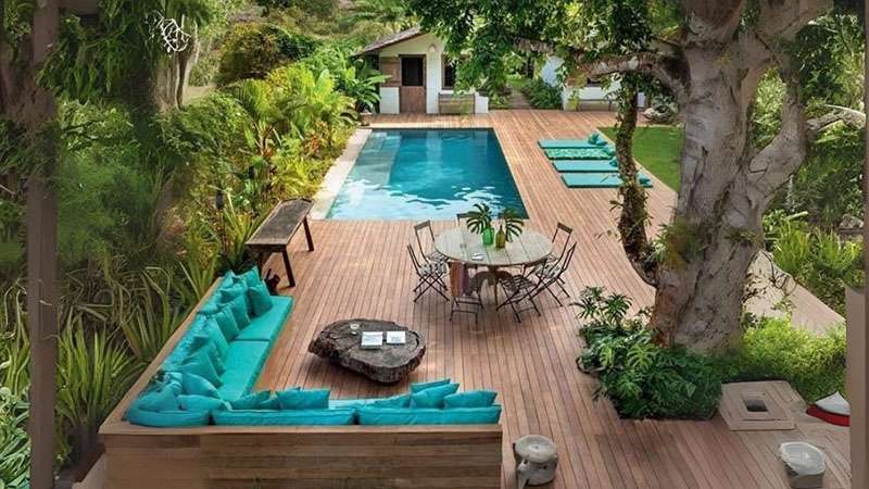 Outdoor relaxation area with a swimming pool and luxurious canopy.