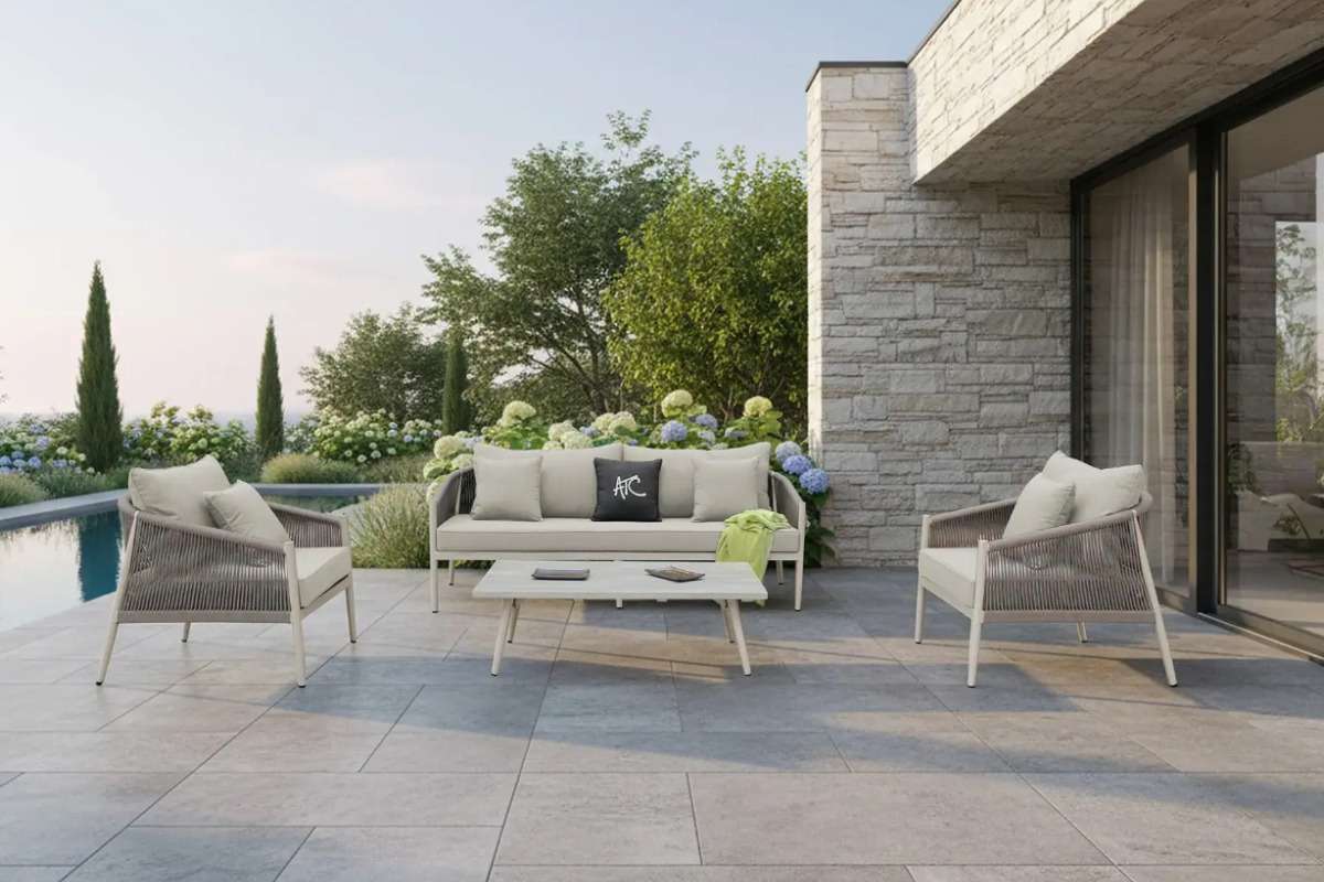 Rope-and-rattan outdoor sofa set on a villa terrace by the pool, showcasing a luxurious resort-style design.