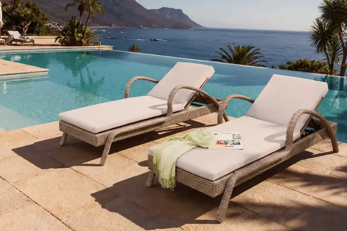 Luxury resort poolside loungers with durable outdoor fabric and comfortable seat cushions.