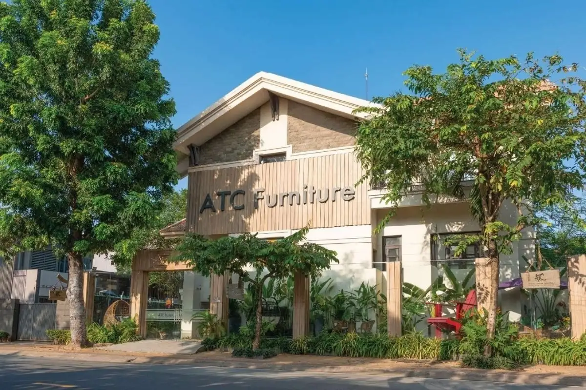 ATC Furniture showroom building surrounded by green trees and modern landscaping, highlighting the brand’s commitment to sustainable living.