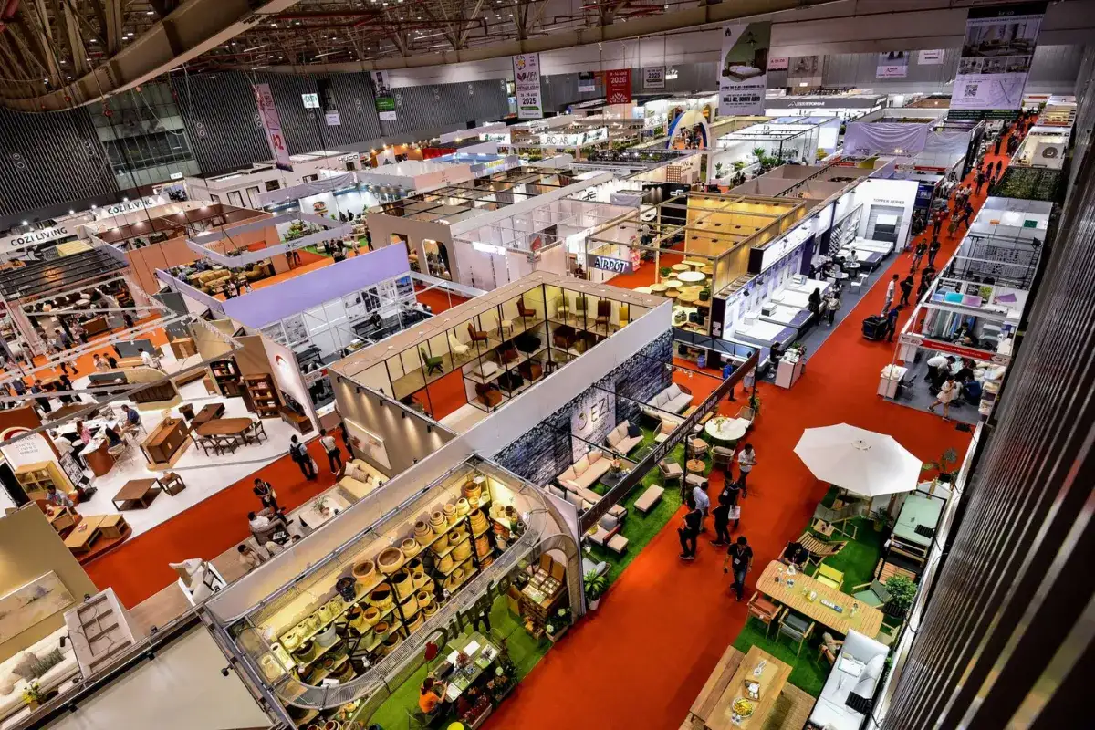 Panoramic view of VIFA Expo exhibition hall in Ho Chi Minh City with multiple furniture booths and red carpet aisles