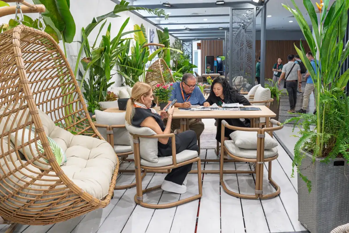 International buyers discussing product details at a rattan furniture booth during VIFA Expo Vietnam