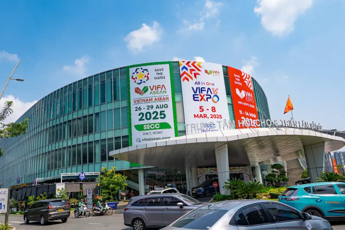 Wide angle shot of VIFA Expo Vietnam showcasing furniture display stands and visitors walking through the trade fair