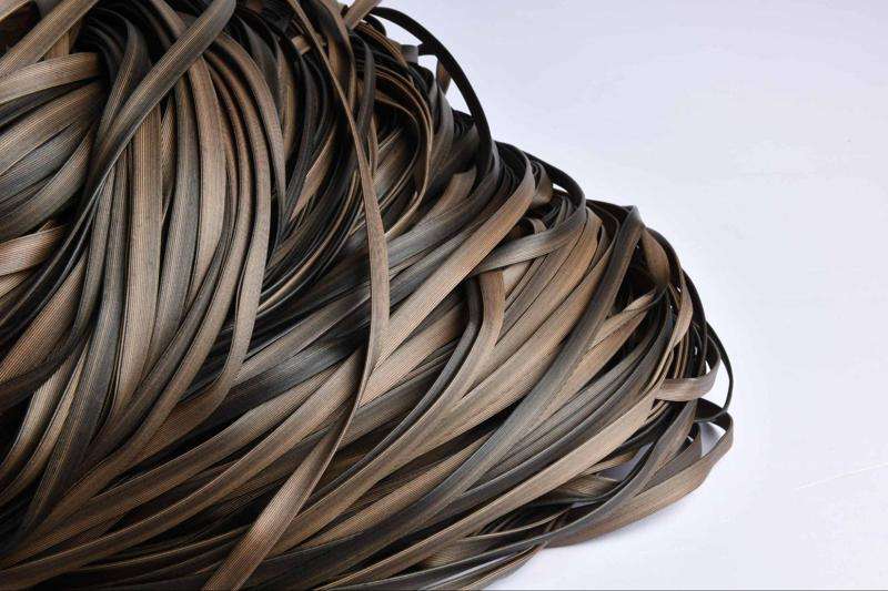 Close-up of HDPE synthetic wicker material in a dark brown tone