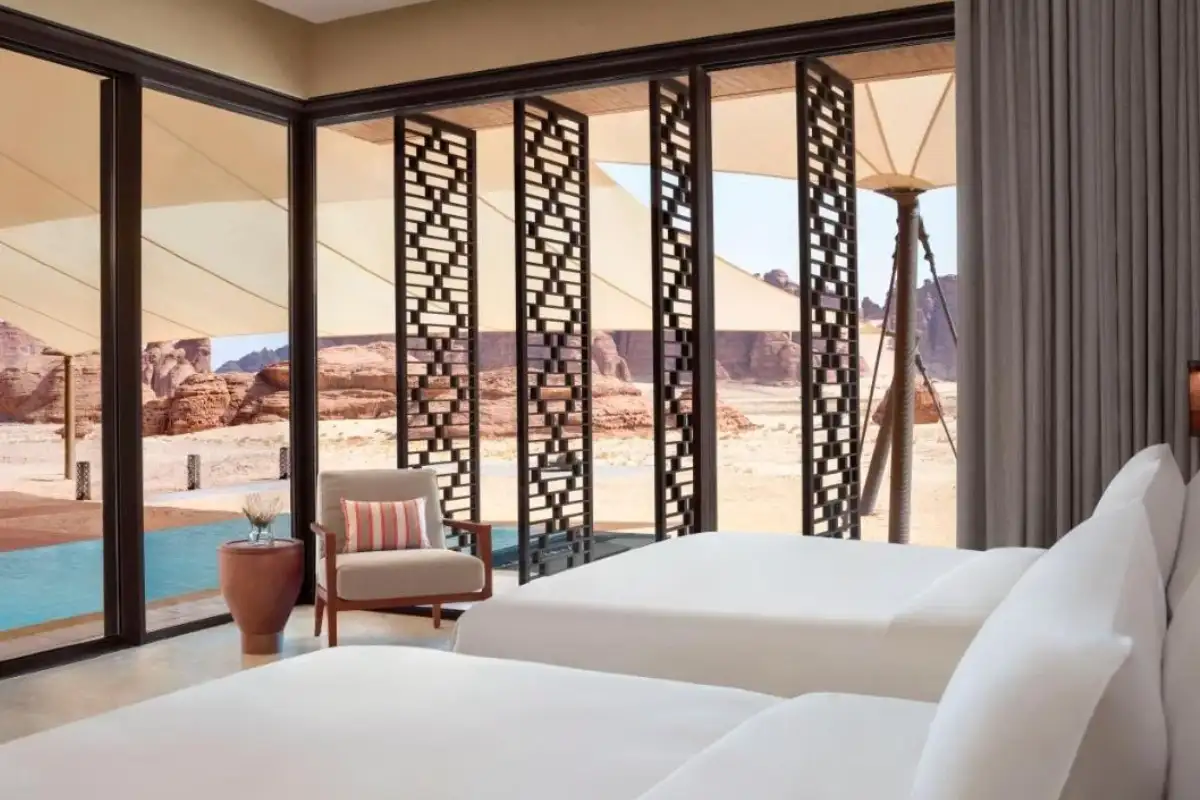 Outdoor villa suite with modern hotel bed furniture, offering a luxurious and relaxing guest experience.  