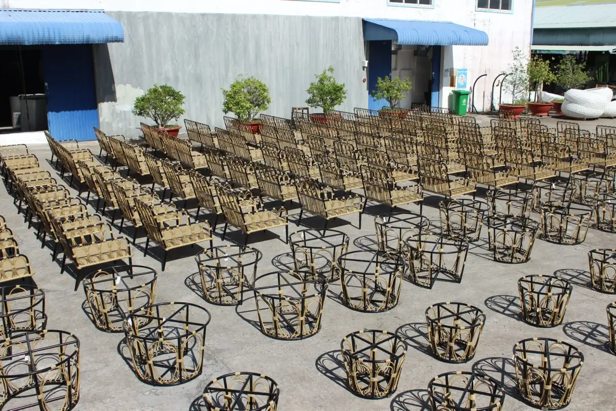Outdoor production yard filled with stacked HDPE rattan chair frames at ATC Furniture's factory in Vietnam