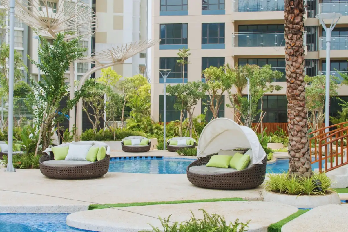 ATC Furniture’s outdoor round daybeds with canopy by the poolside at Estella Residence, District 2,  blending modern comfort with tropical landscaping.