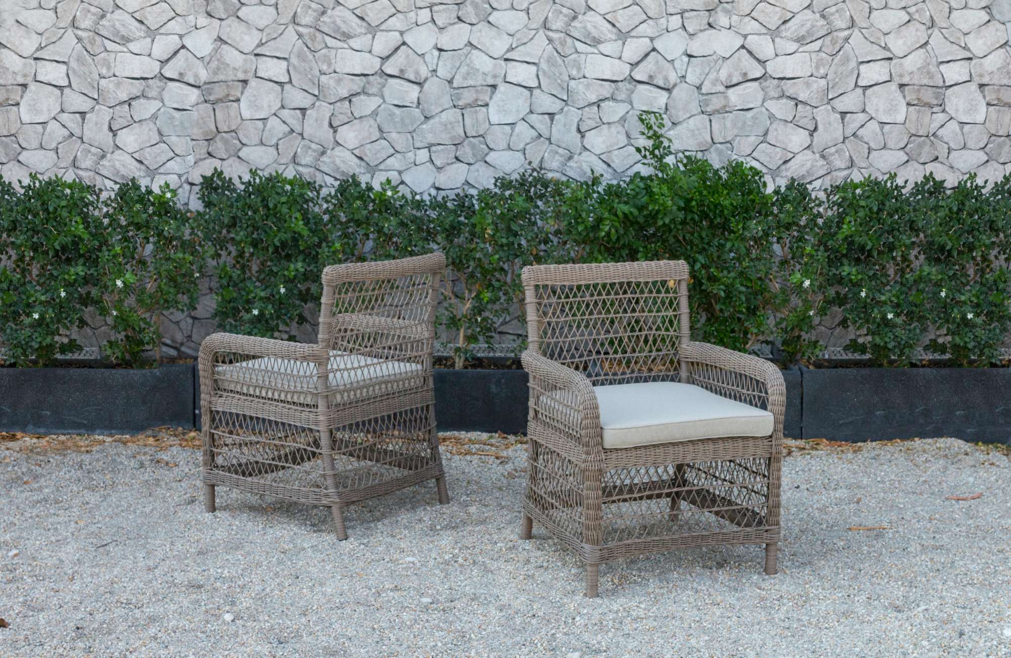 Gray synthetic rattan chairs for garden decor.