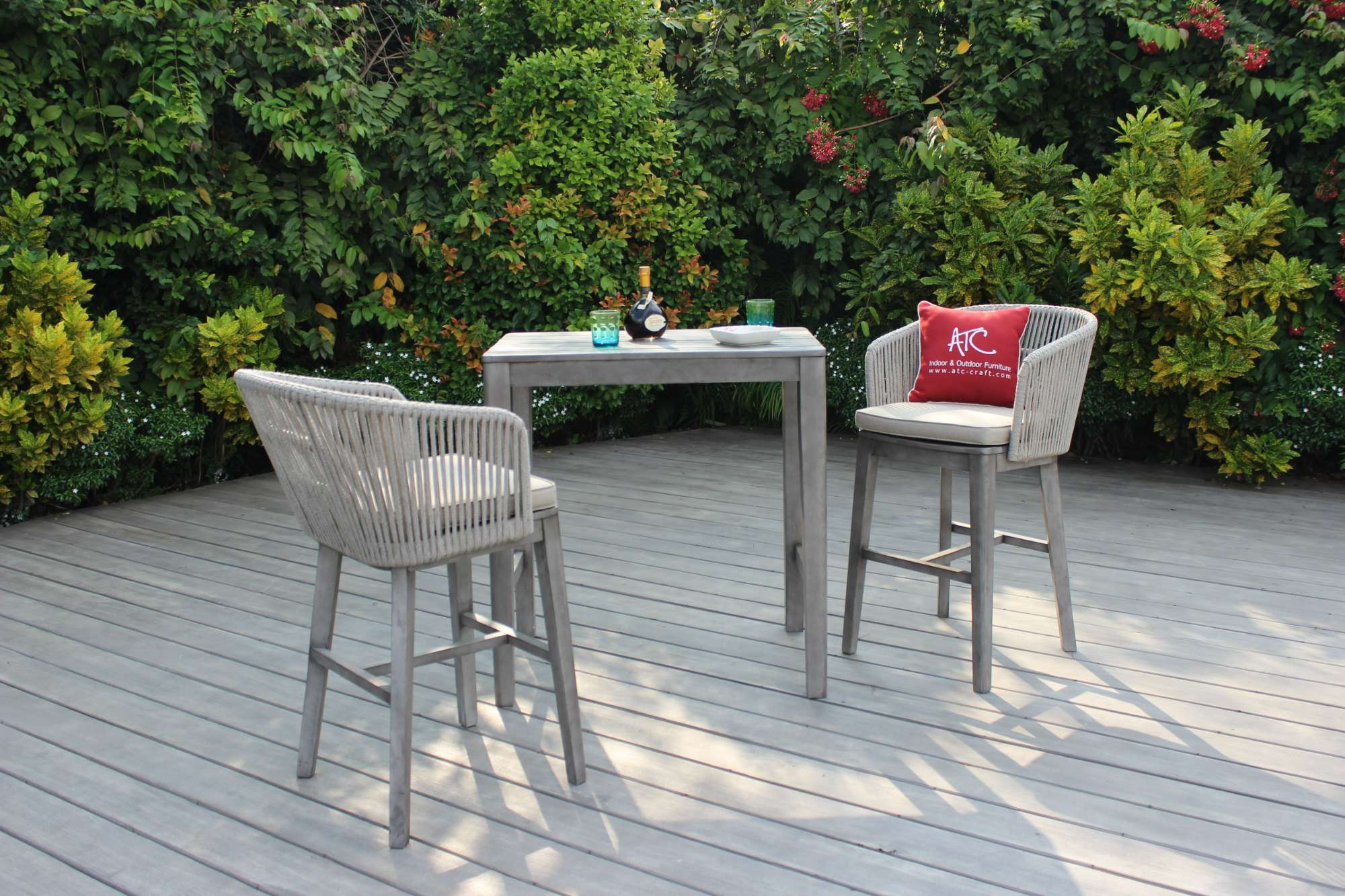 Outdoor relaxation space featuring a durable wicker table and chairs.