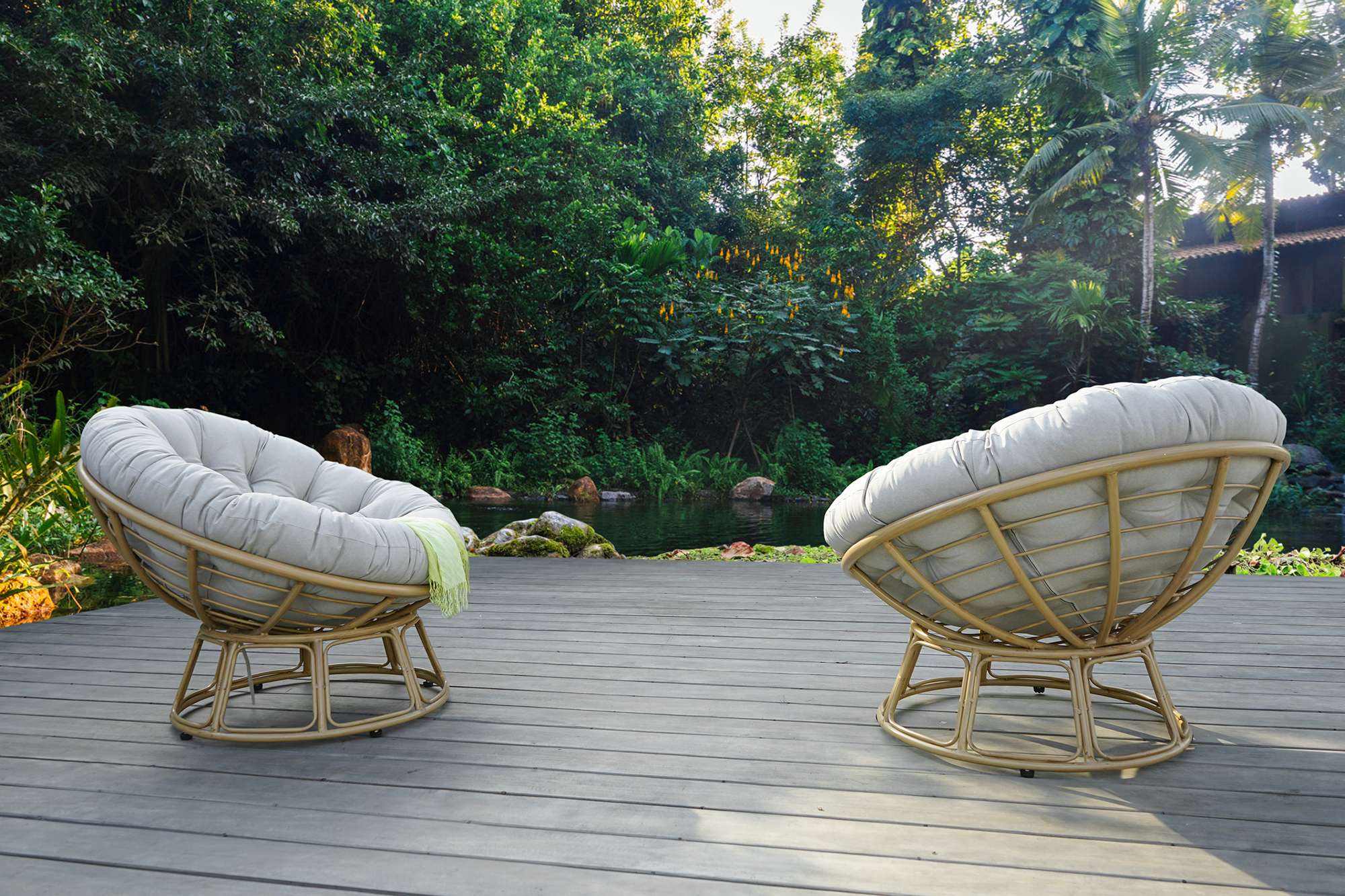 Outdoor Papasan chair with soft cushions and bamboo frame.