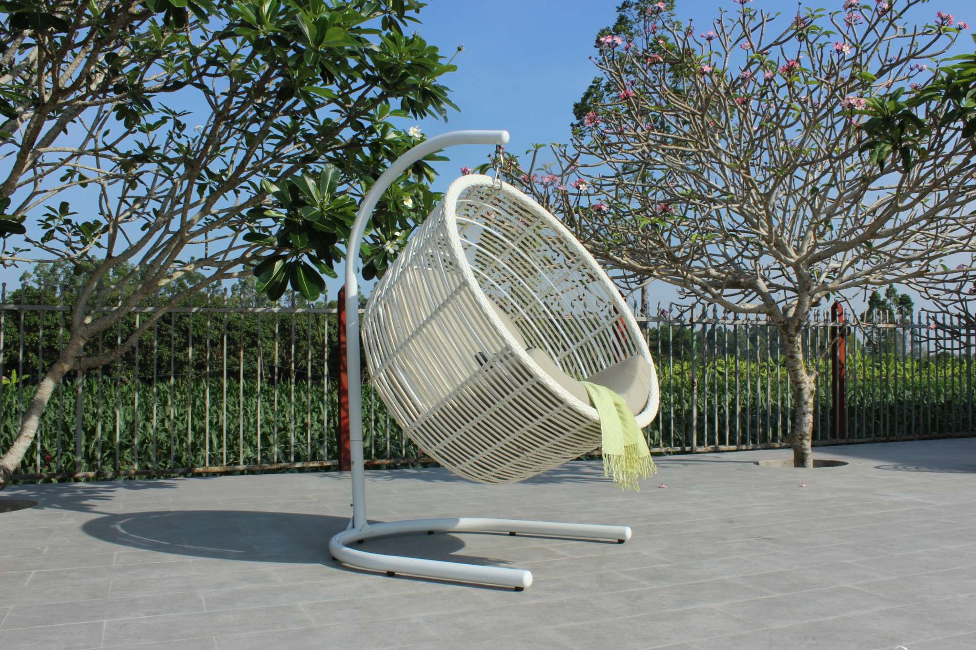 White outdoor swing chair with elegant design.