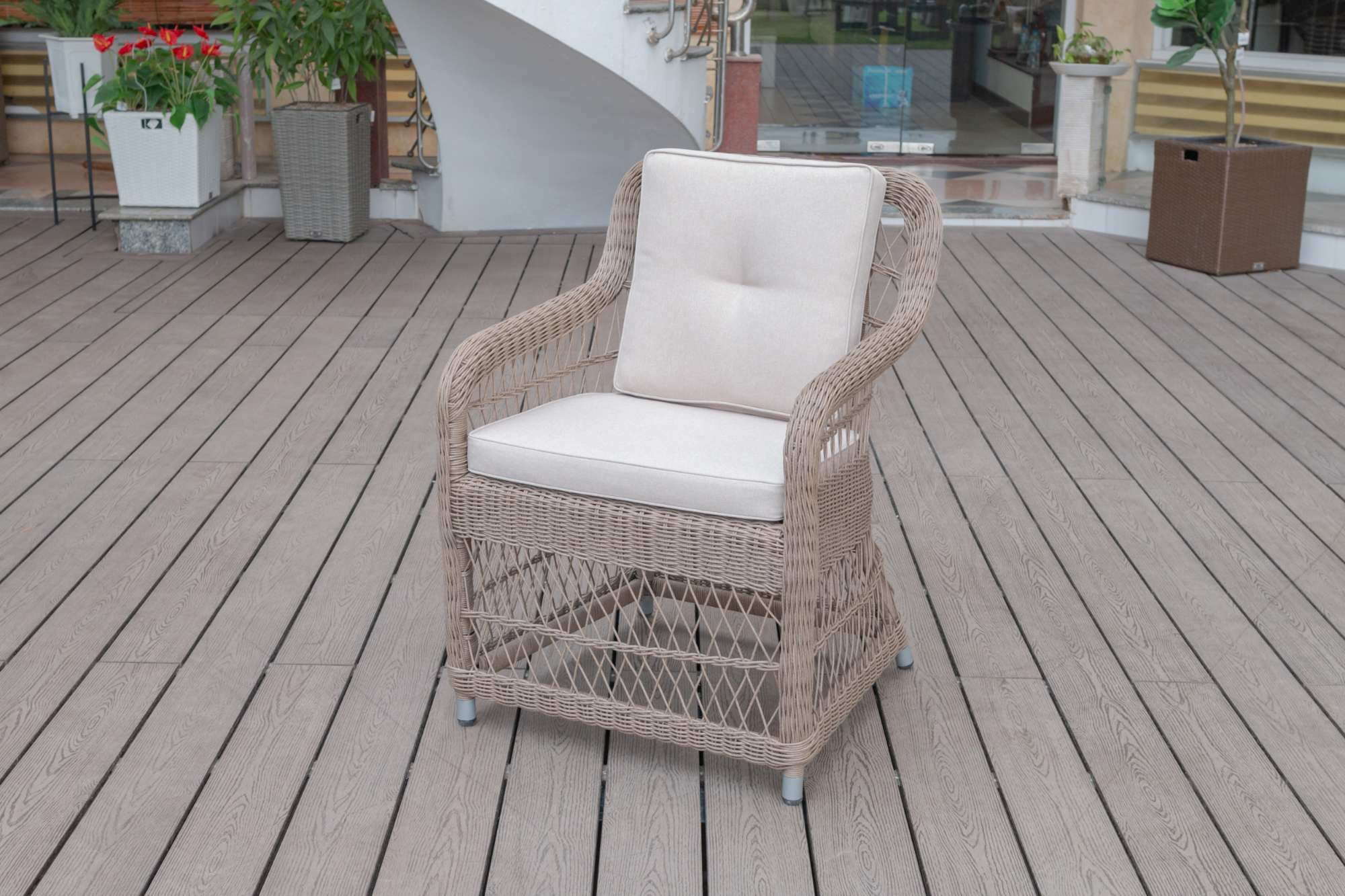 Light-colored cushioned rattan chair on a rooftop terrace.