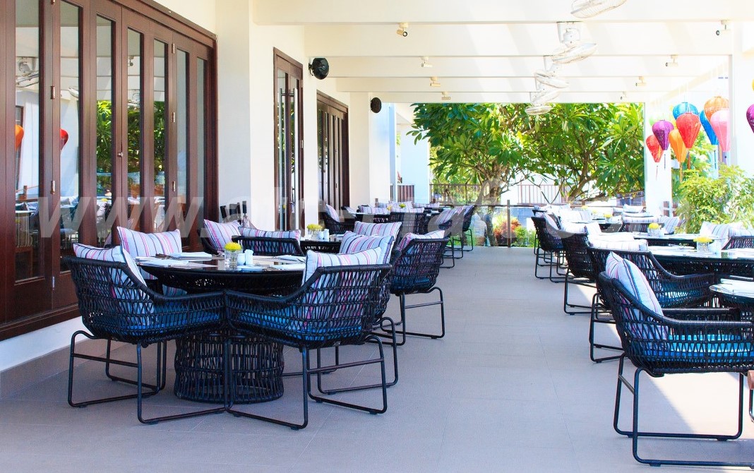 Wicker dining sets at outdoor dining area of Pullman Danang Beach Resort