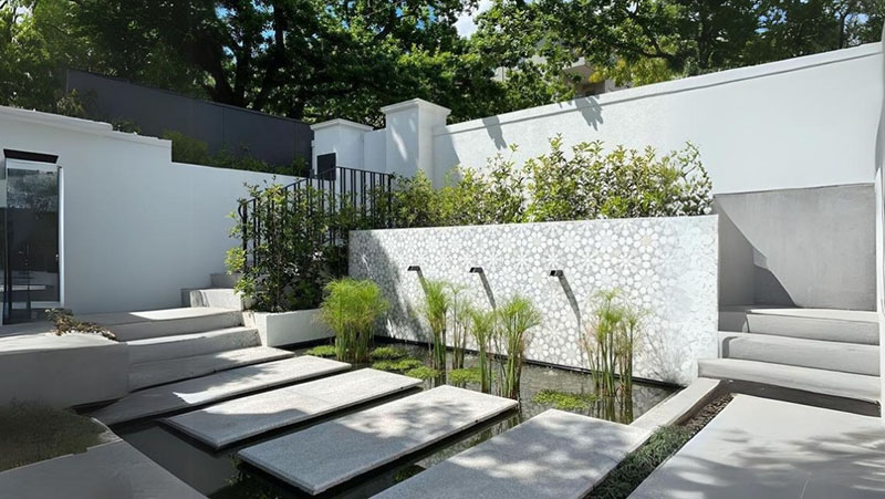 Water details leverage terraced patio to a higher aesthetic level