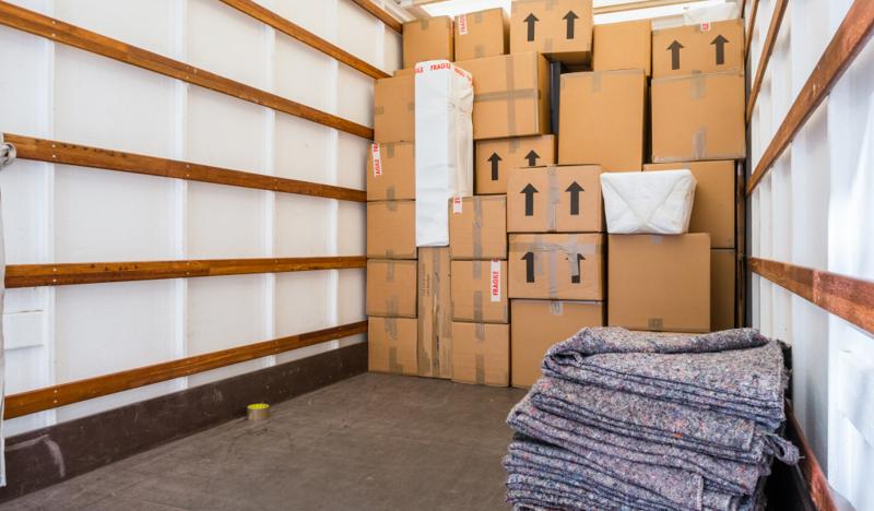 Boxes and blankets inside a moving truck, highlighting the importance of shipping costs