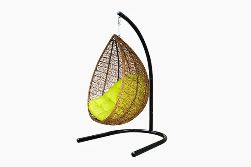 Outdoor hanging chair made from poly rattan with a teardrop shape and bright green cushion on a black metal stand